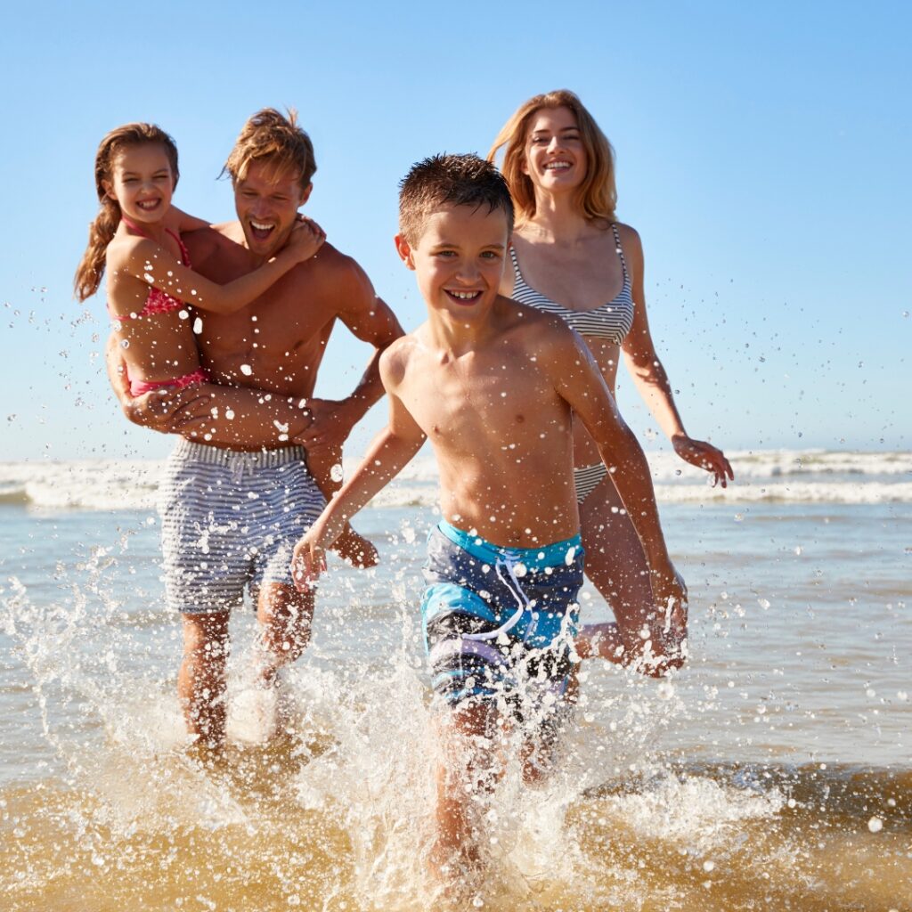 a group of people running in the water