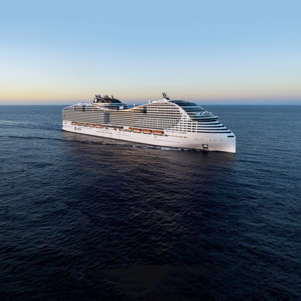 MSC Cruises elegant ship sailing into the sunset on calm seas